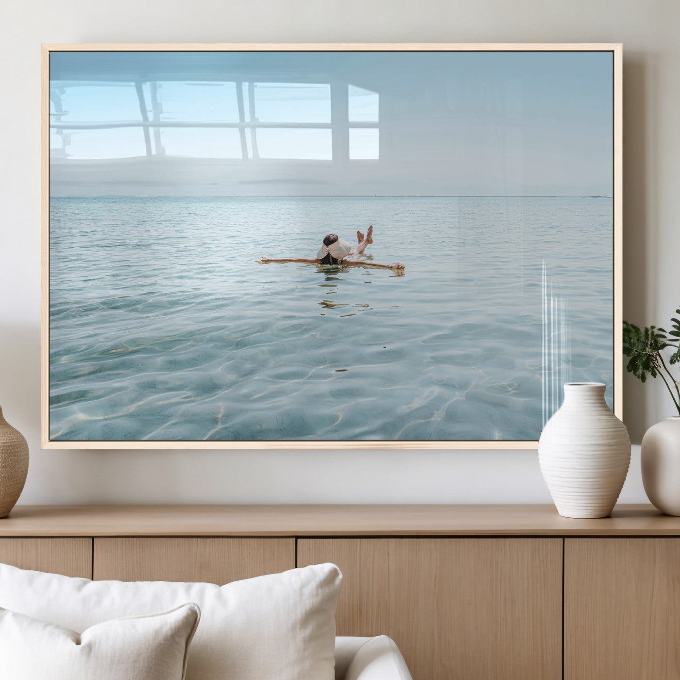 A peaceful minimalist scene of a person floating on crystal-clear water, surrounded by a vast open horizon, capturing relaxation and serenity in a tranquil aquatic setting.
