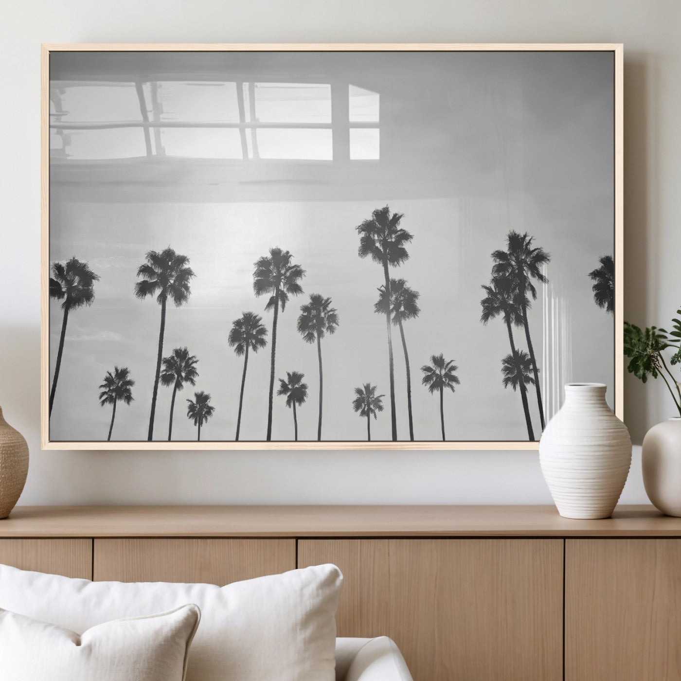 A black and white minimalist scene featuring tall palm trees silhouetted against a bright sky, creating a dreamy and timeless tropical aesthetic.