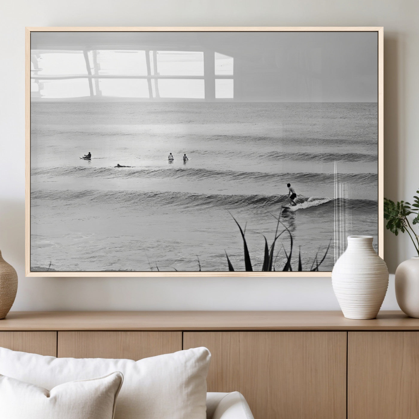 Monochrome canvas of surfers on calm ocean waves, ideal for minimalist coastal or beach-inspired interior decor.