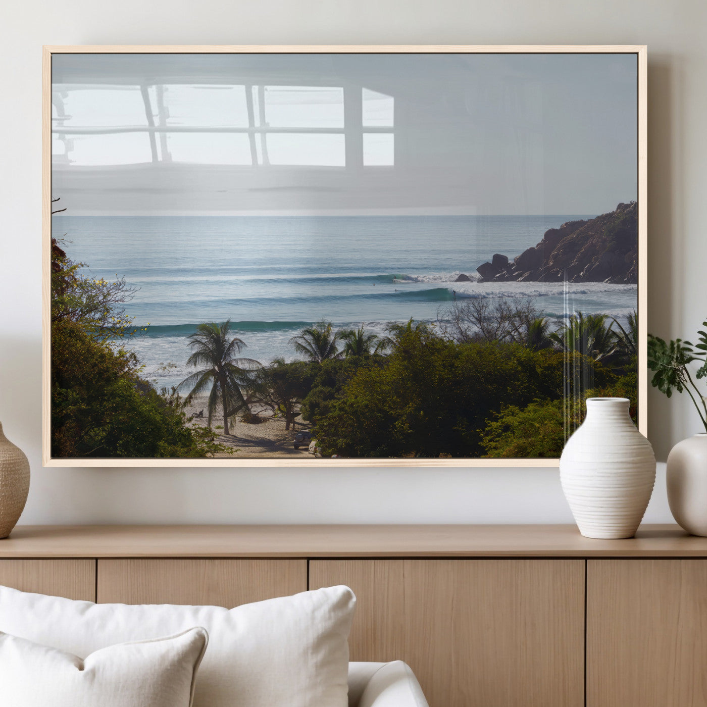 View of calm ocean waves with palm trees and a tropical coastline, ideal for coastal boho or beach-themed wall decor.
