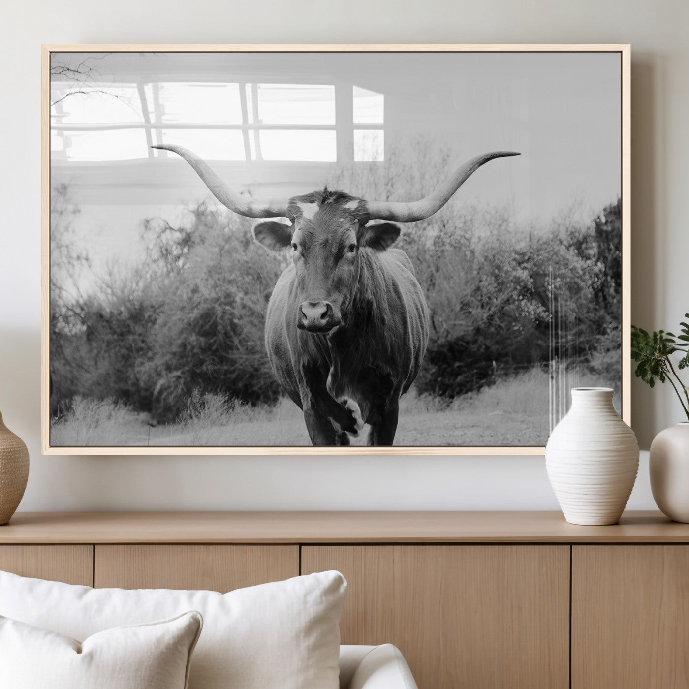 Black and white photo of a Longhorn cow facing camera, ideal for rustic, farmhouse, or western-themed home wall decor.