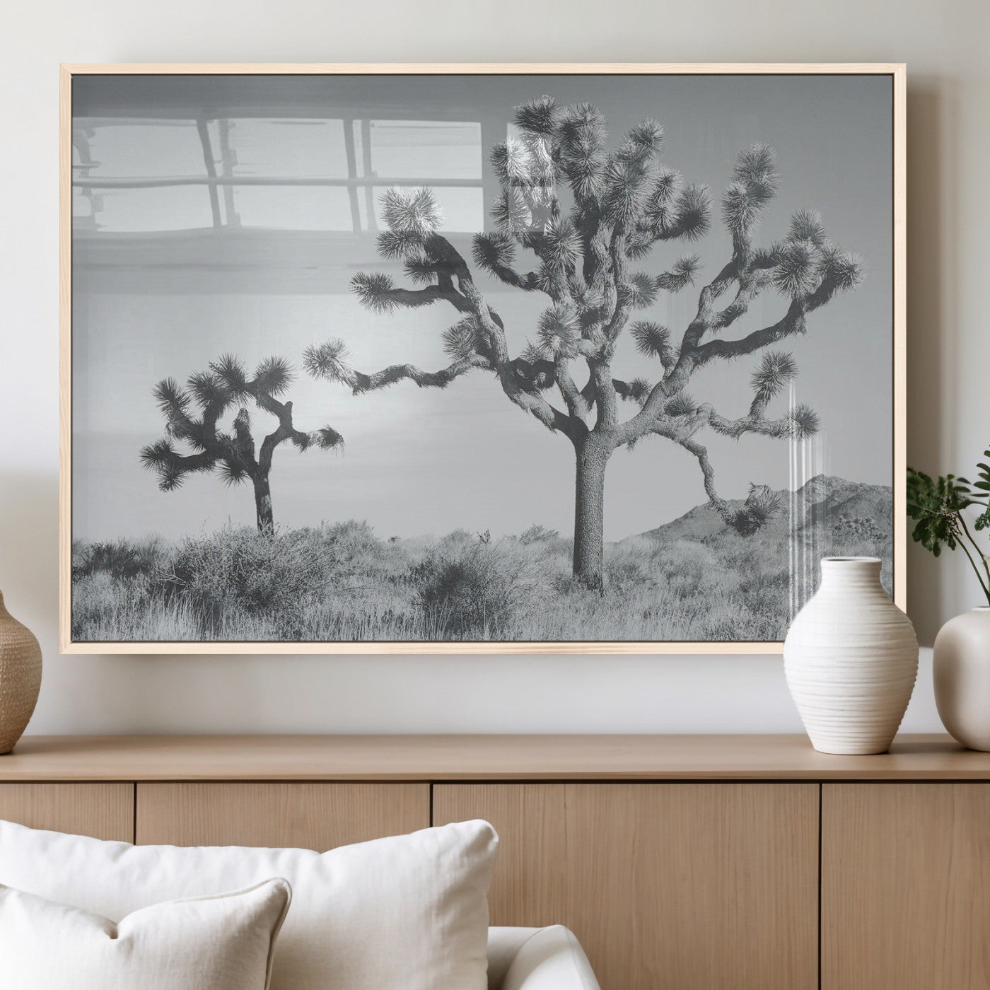 Two Joshua trees in a black and white desert landscape with distant hills, ideal for boho or rustic interior wall styling.