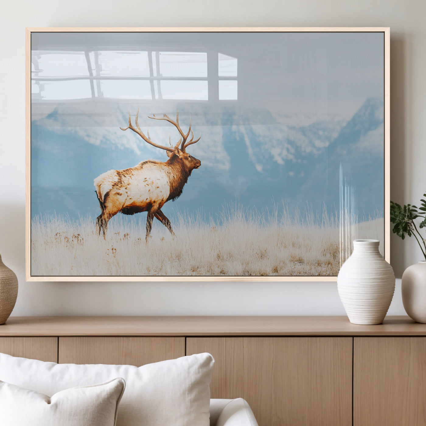Majestic elk standing on dry grassland with snowy mountains in the background, ideal for rustic or lodge-inspired wall decor.