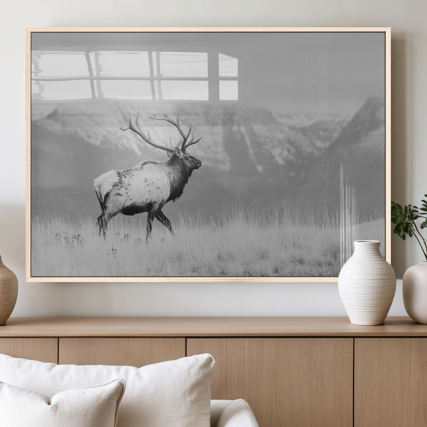 Black and white elk standing in front of snowy mountain range, perfect for rustic lodge or nature-inspired wall decor.