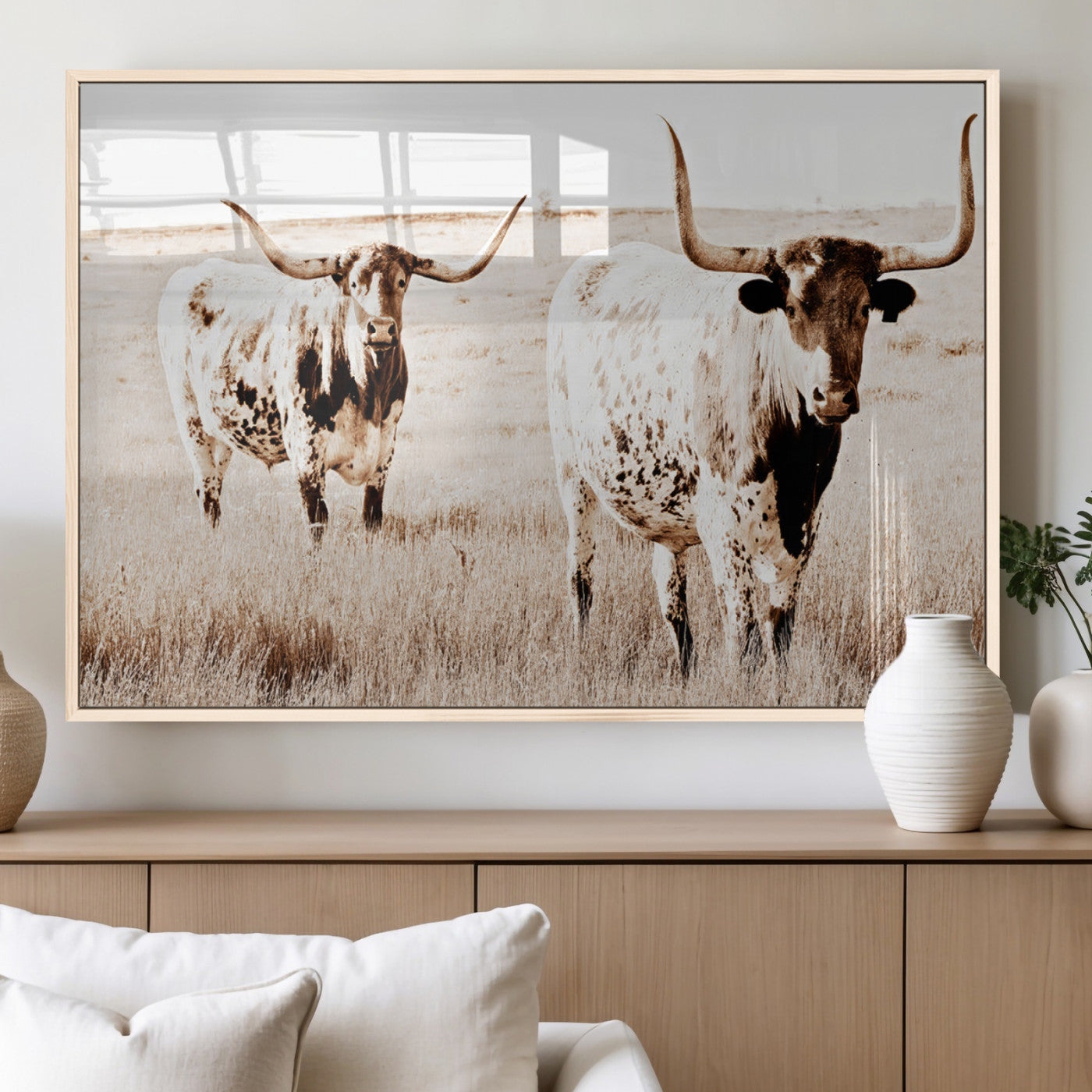 Two Texas longhorn cows standing in a sepia-toned pasture, evoking rustic charm perfect for farmhouse or western country interiors. (