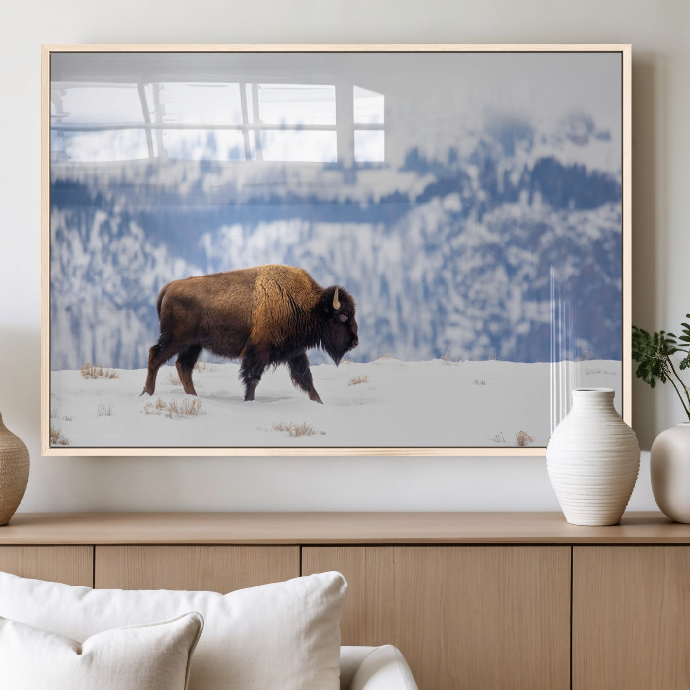 A lone bison walks across snowy ground with blue-toned mountain range behind, ideal for rustic or western farmhouse interiors.
