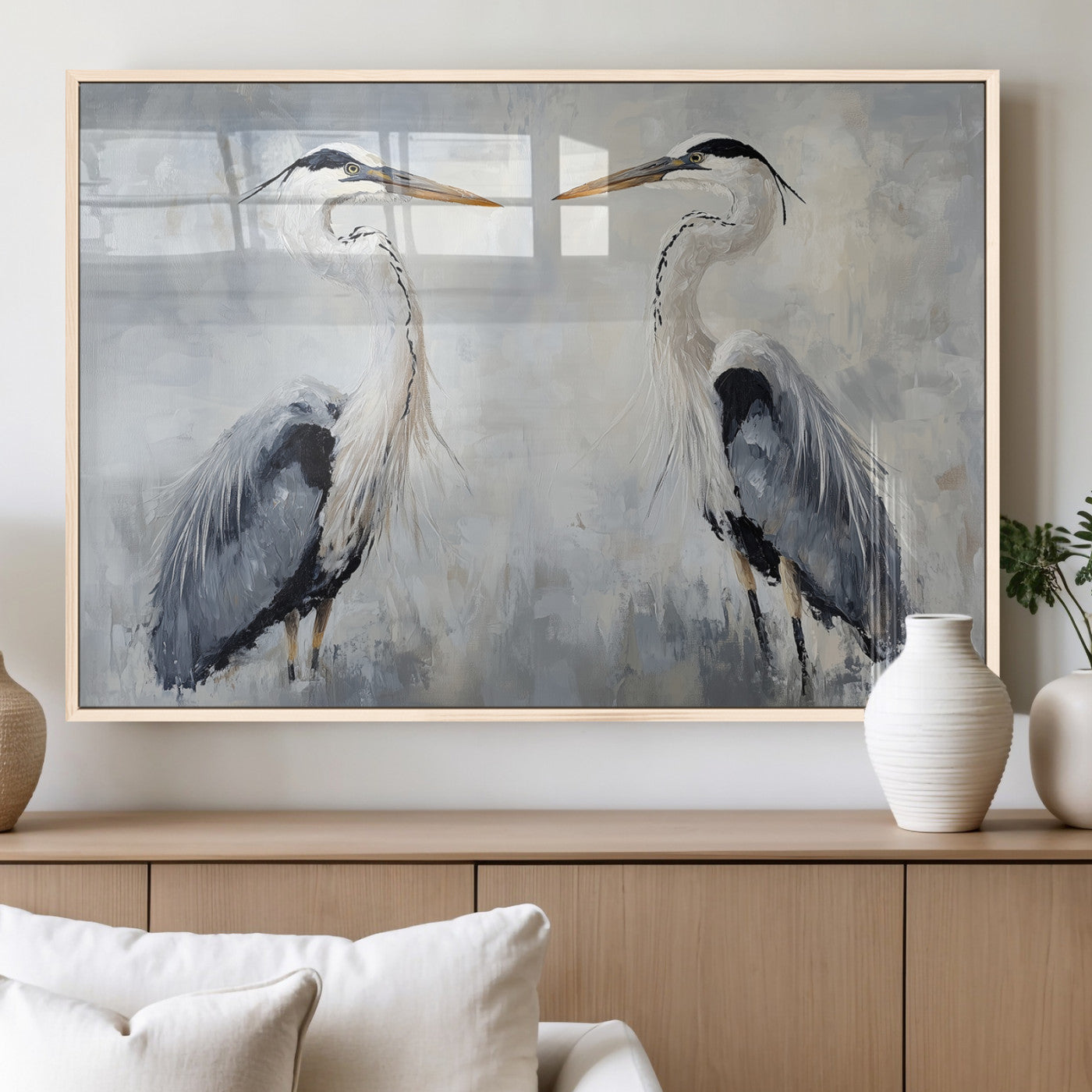 Two herons facing each other on a soft-toned background with blue-grey feathers, perfect for tranquil, coastal or nature-themed interiors.