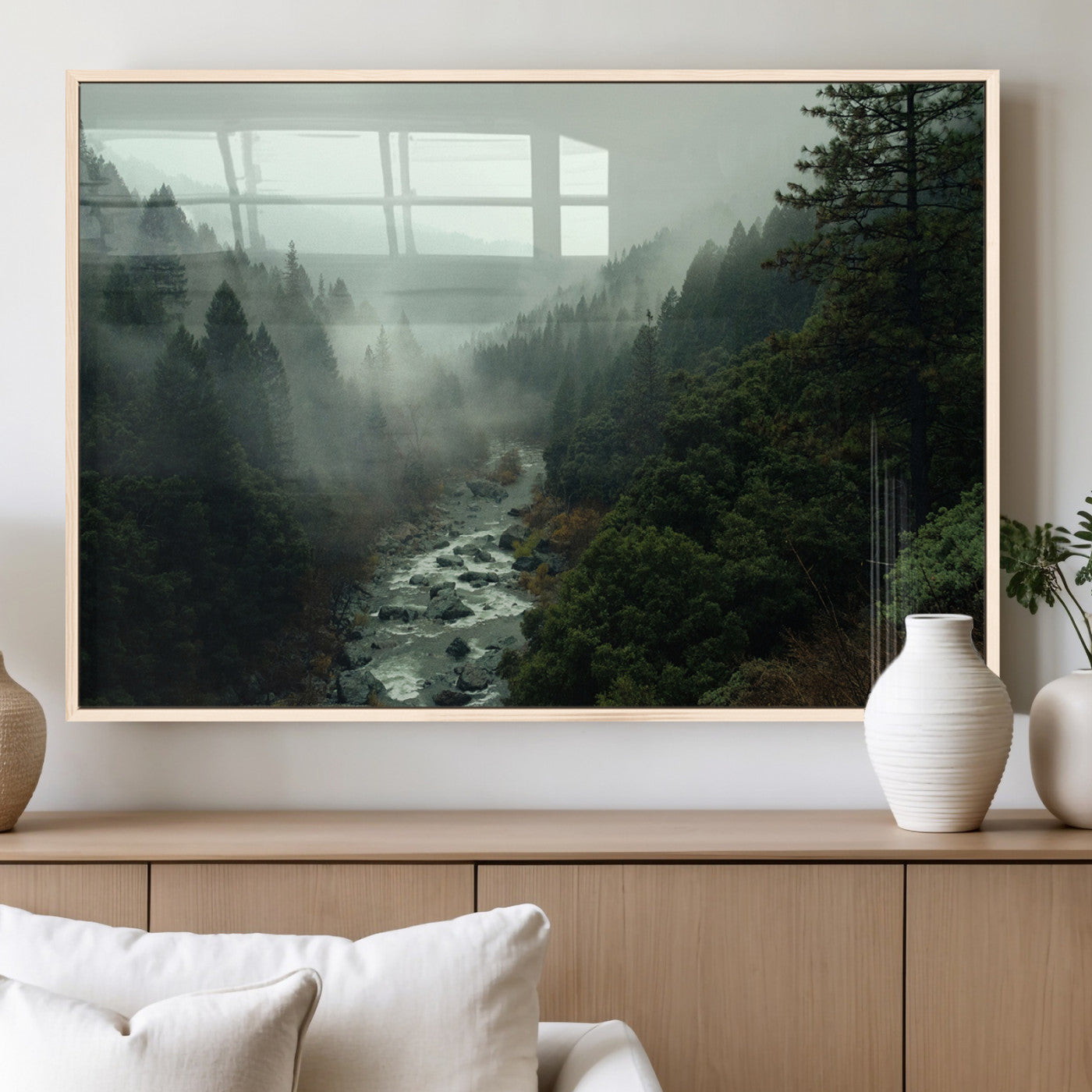 Misty forest with a winding river flowing through lush green mountains, creating a tranquil and moody wilderness landscape.