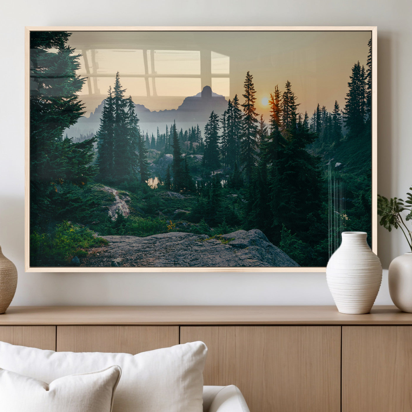 Mountain landscape with evergreen trees at sunset, casting a golden glow over the wilderness, creating a peaceful and rustic nature scene.