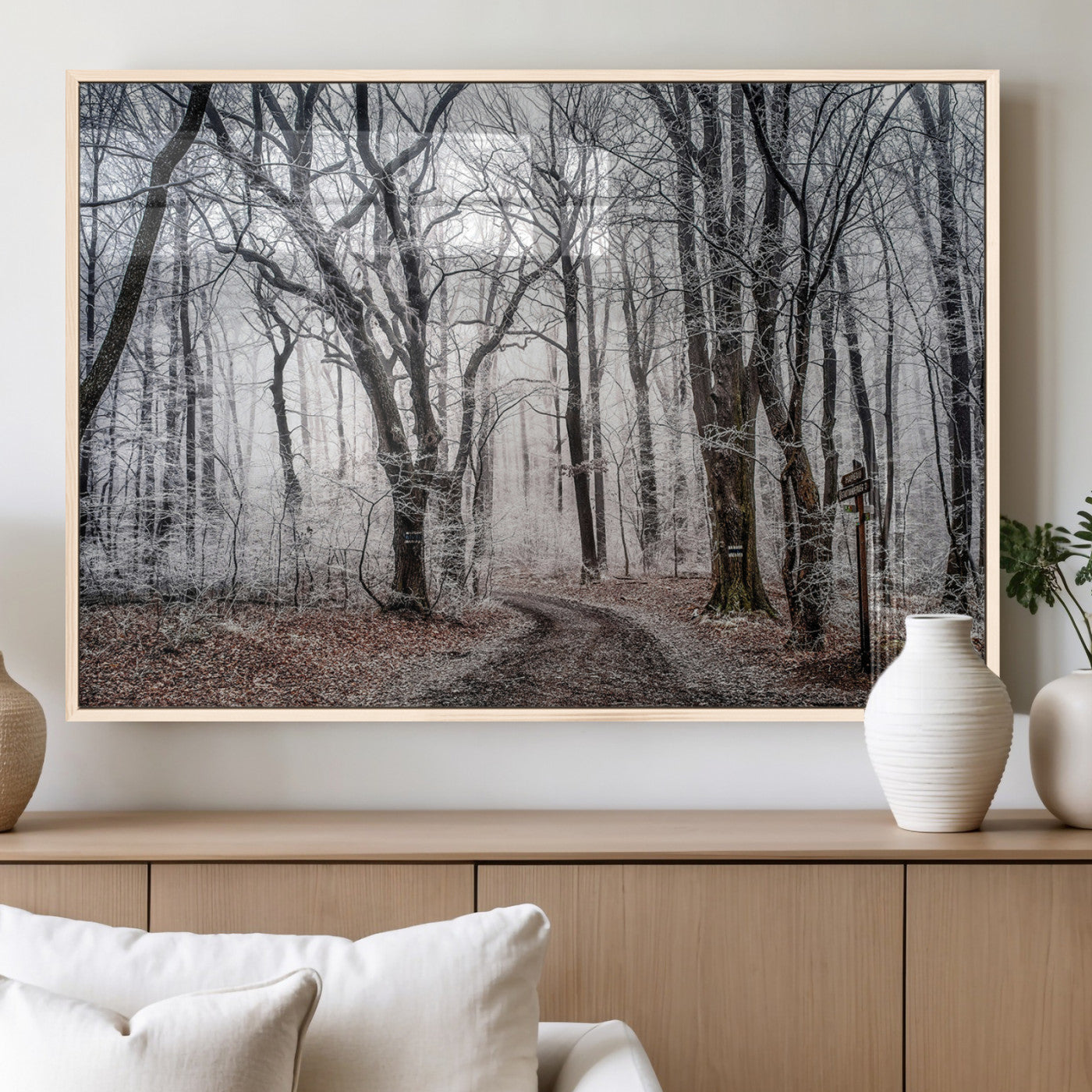 Snow-covered trees in a misty winter forest with a winding path, creating a serene and mysterious atmosphere, perfect for nature-inspired wall art.