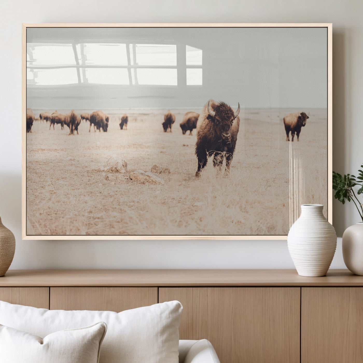 Herd of bison roaming a vast prairie with golden grass under a soft sky, creating a rustic and Western landscape, ideal for wall art.