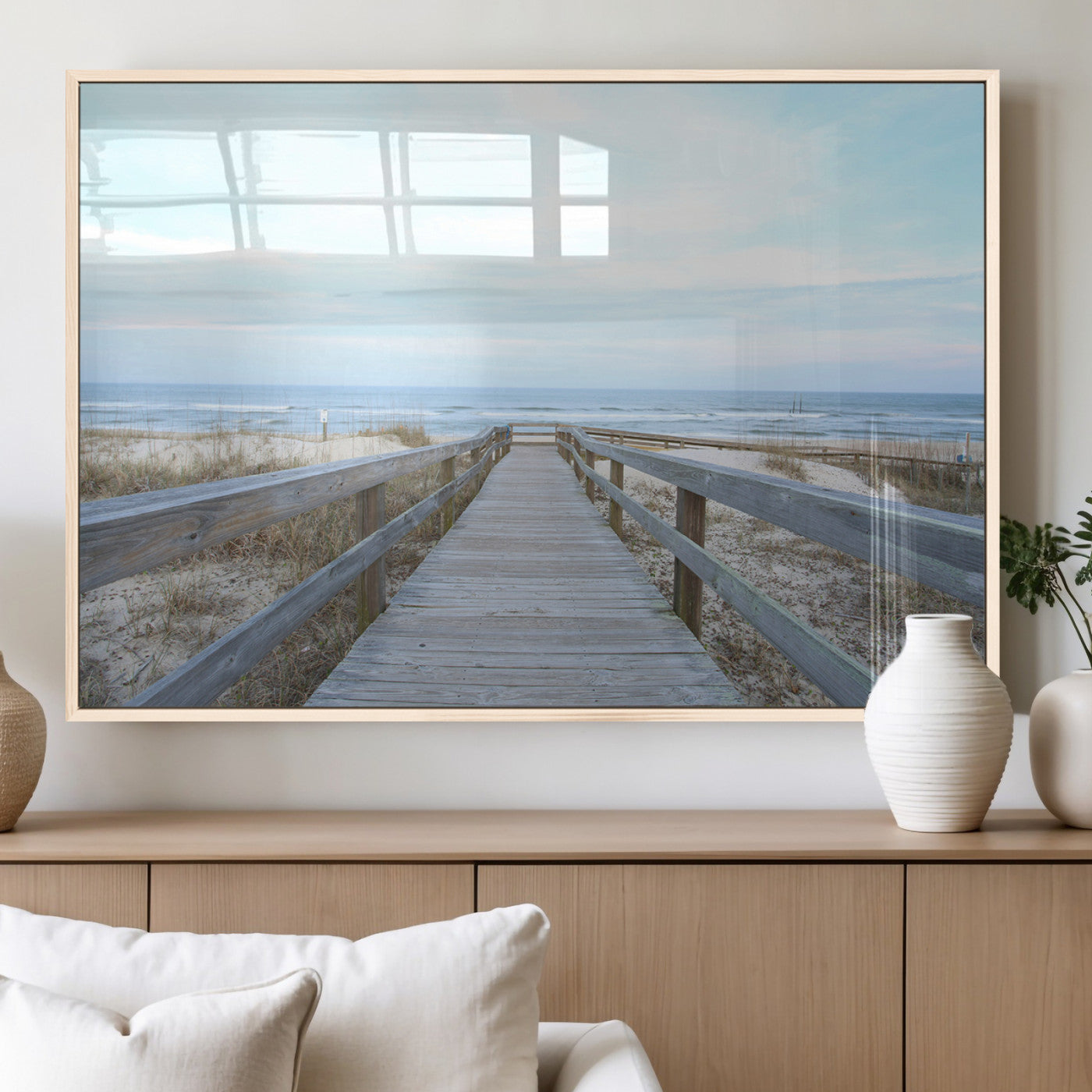 Wooden boardwalk leading to a peaceful beach with gentle ocean waves under a soft pastel sky, perfect for coastal and nautical home decor.