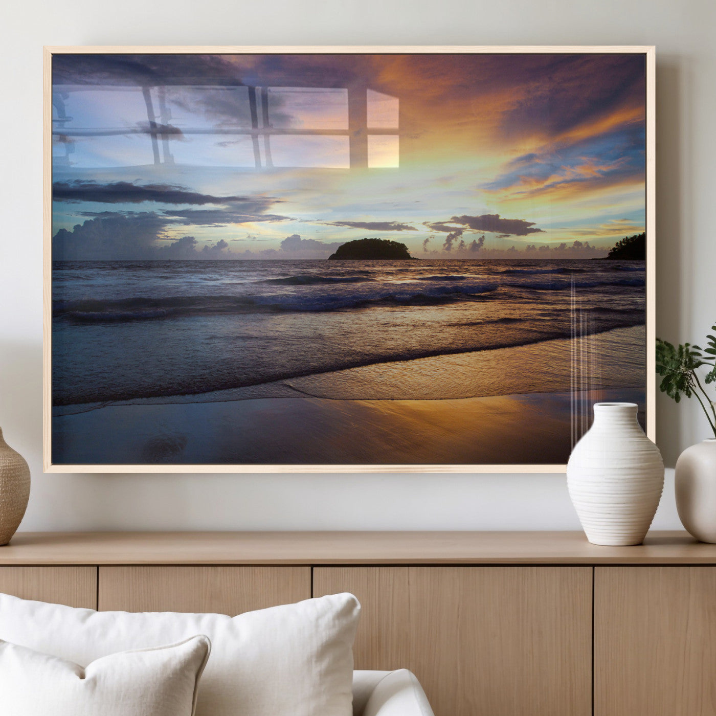 A tropical beach at sunset with waves gently washing ashore, reflecting golden and purple hues in the sky, creating a tranquil coastal scene.