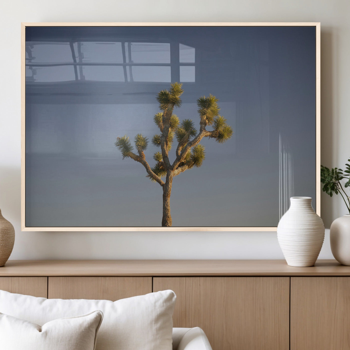 A lone Joshua Tree standing against a deep blue sky, capturing the serene and rugged beauty of the Southwestern desert landscape.