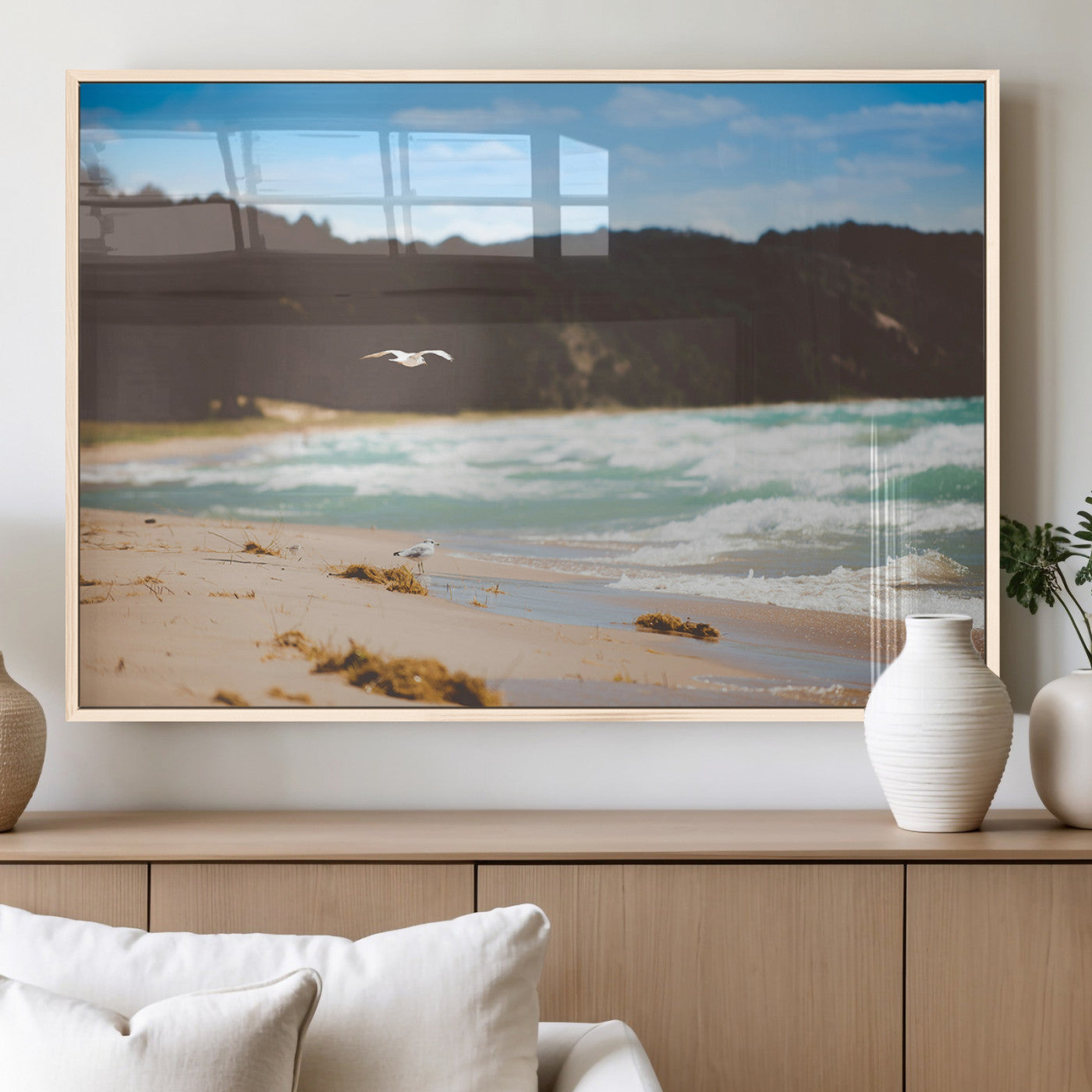 Serene beach scene with gentle ocean waves, sandy shore, and a seagull flying under a blue sky, perfect for coastal and nature-inspired decor.