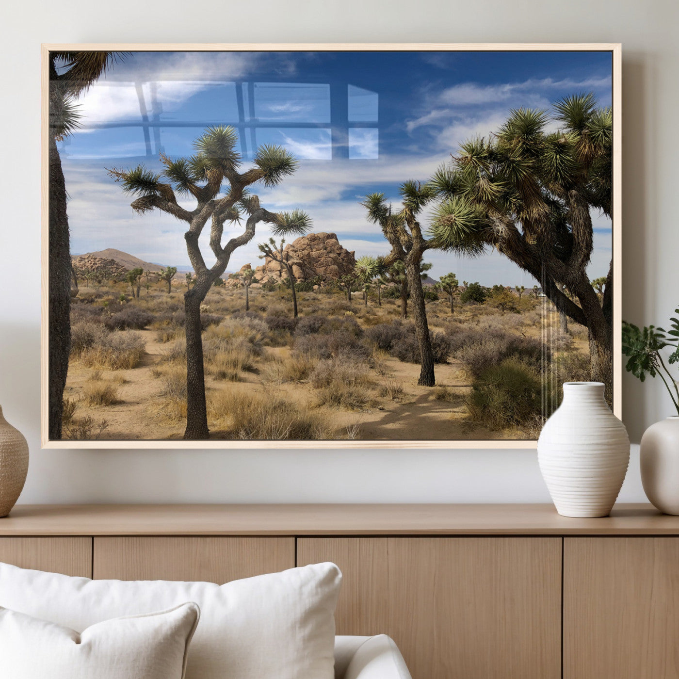 Scenic Joshua Tree landscape with rugged desert terrain, golden dry grass, and a deep blue sky, creating a warm, rustic Southwestern aesthetic.