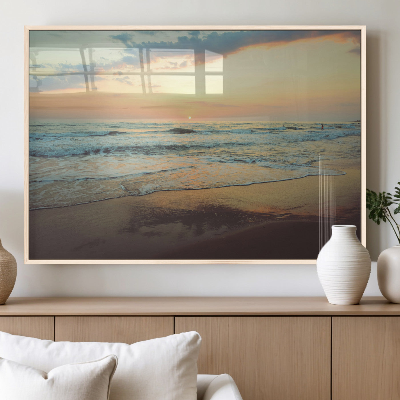 Warm sunset over gentle ocean waves with pastel sky and reflections on wet sand, creating a calm and soothing beach ambiance.