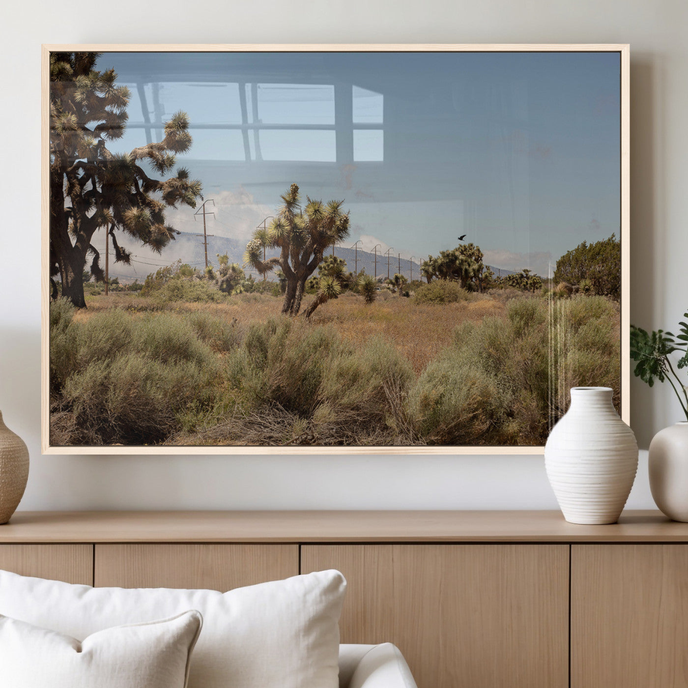 Scenic desert landscape with Joshua trees, dry grass, and distant mountains under a clear blue sky, perfect for southwestern and rustic decor.