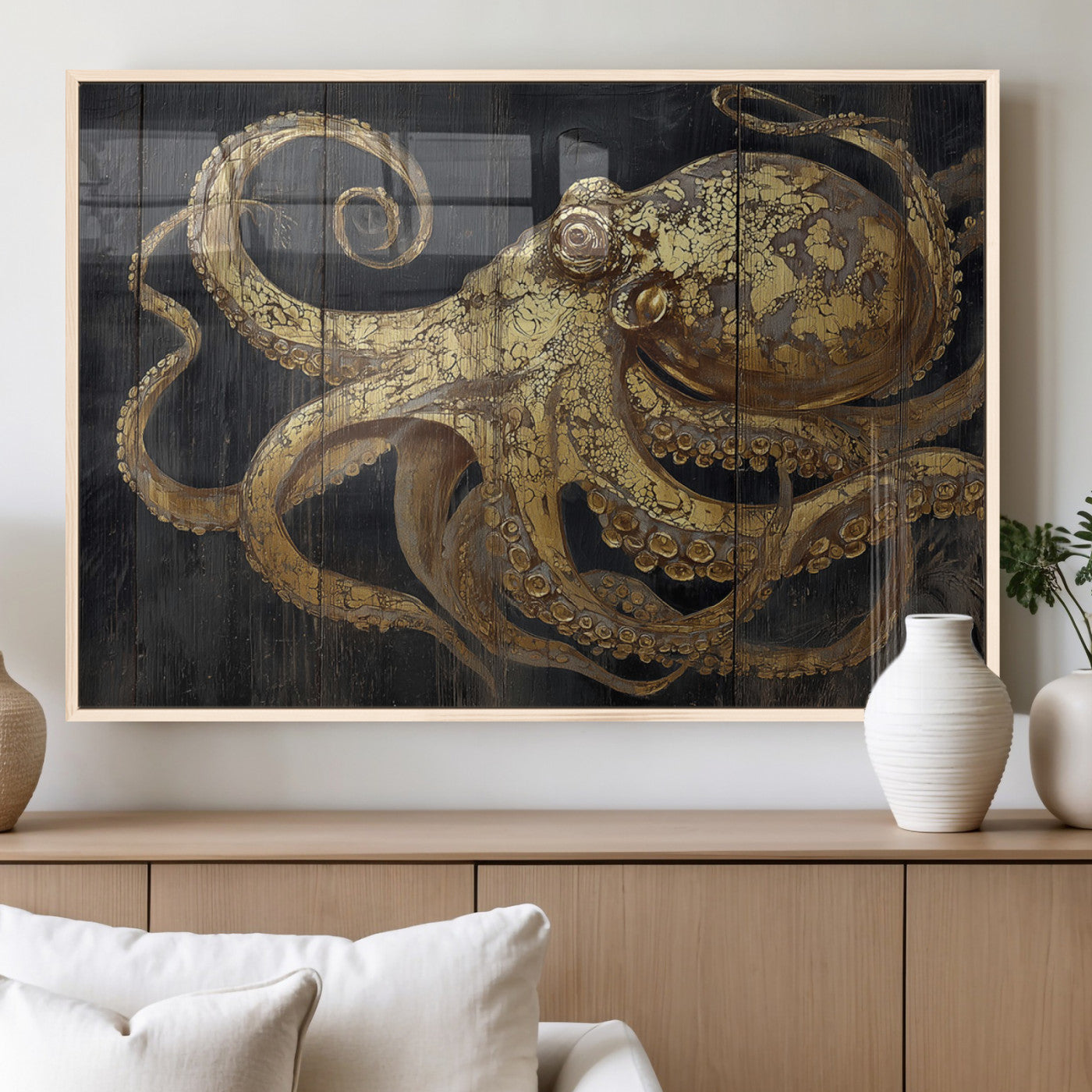 A detailed gold illustration of an octopus on black wooden planks, showing its intricate tentacles and textured skin in an artistic style.