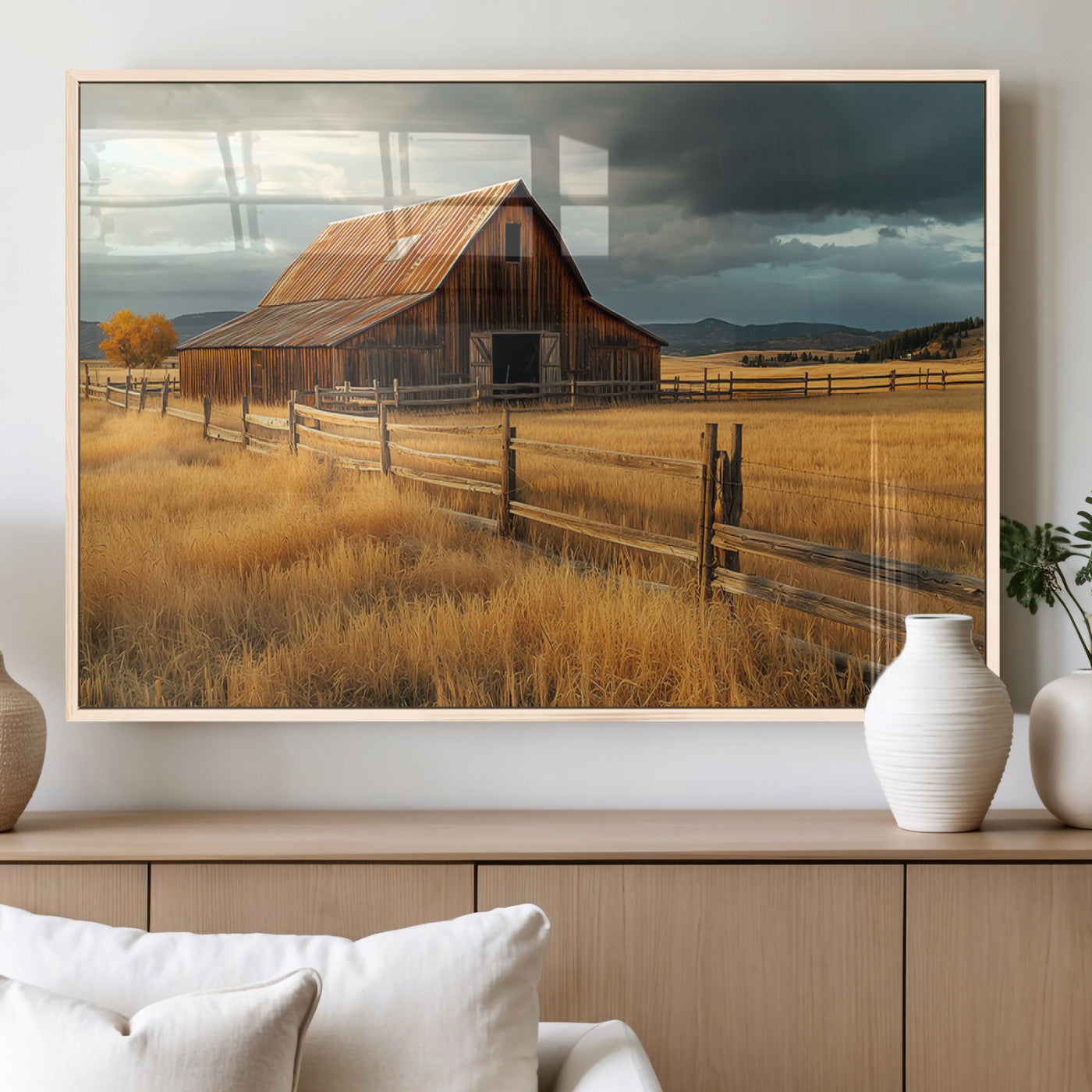 "Golden fields surrounding a rustic barn with a weathered roof, a wooden fence, and dramatic skies with sunlight breaking through the clouds."