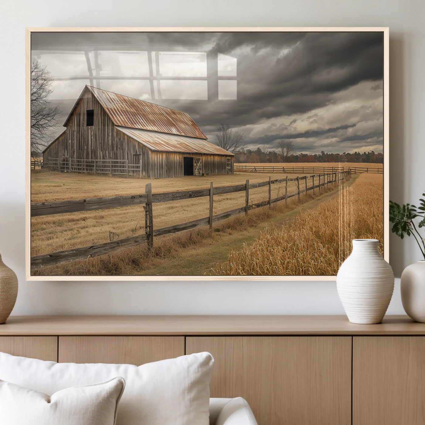 "Rustic barn with a weathered metal roof, surrounded by a wooden fence and golden fields under an overcast sky with dramatic clouds."