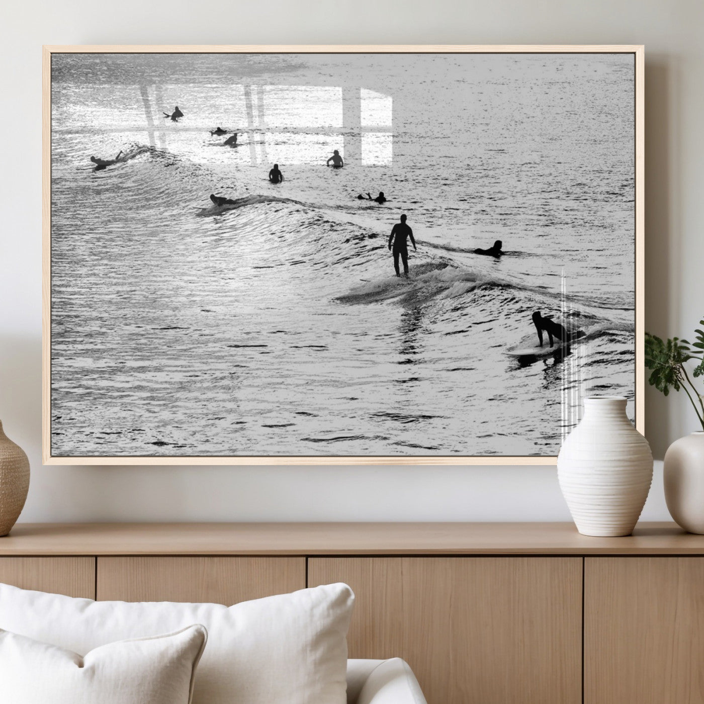 19970637-MGV-CV-60X30-3P_Natural-Black and white artistic view of surfers riding and paddling on waves in the ocean, capturing the dynamic motion and energy of surfing