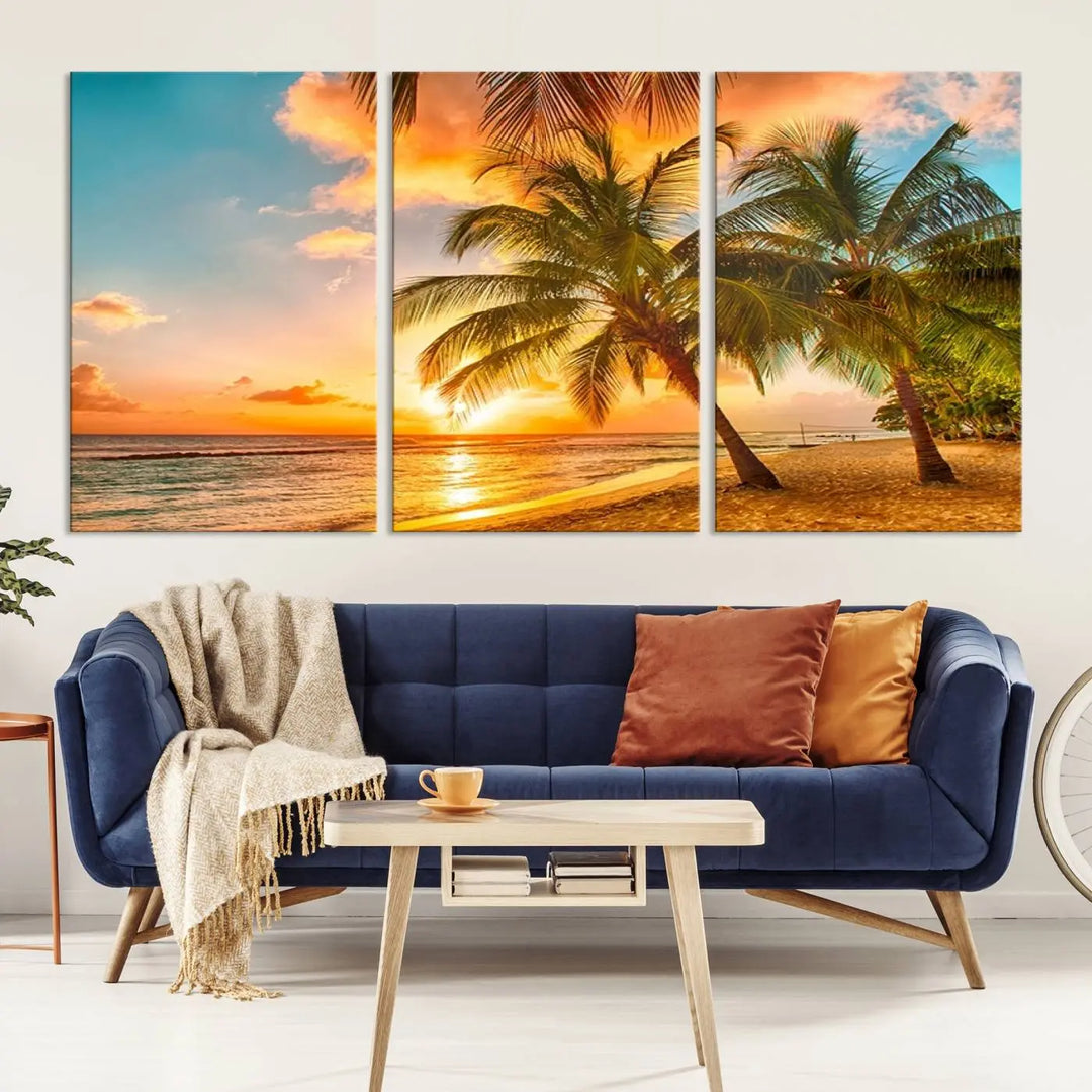 The Tropical Sunset Wall Art Print features a vibrant beach scene with palm trees and an ocean view highlighted by a golden sunset.