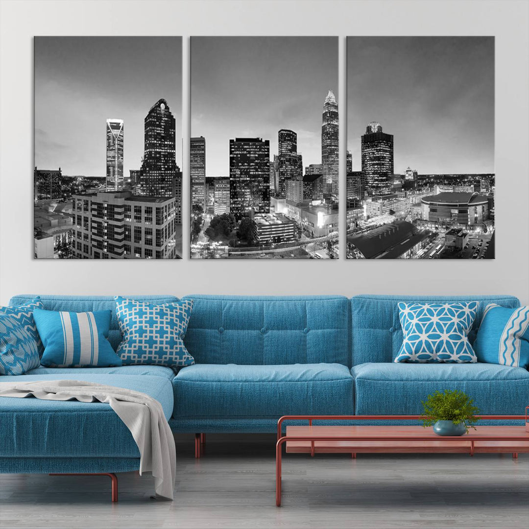 The "Charlotte City Cloudy Skyline Black and White Wall Art Cityscape Canvas Print" hangs on a dark wall, showcasing its UV-protective properties for enduring beauty.