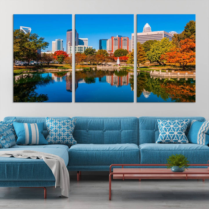 The "Charlotte City Autumn Morning Blue Skyline Cityscape View Wall Art Canvas Print" showcases a cityscape with vibrant autumn trees reflected in a lake. Its gallery-wrapped edges add depth to the scene, while the UV-protective coating ensures lasting brilliance.