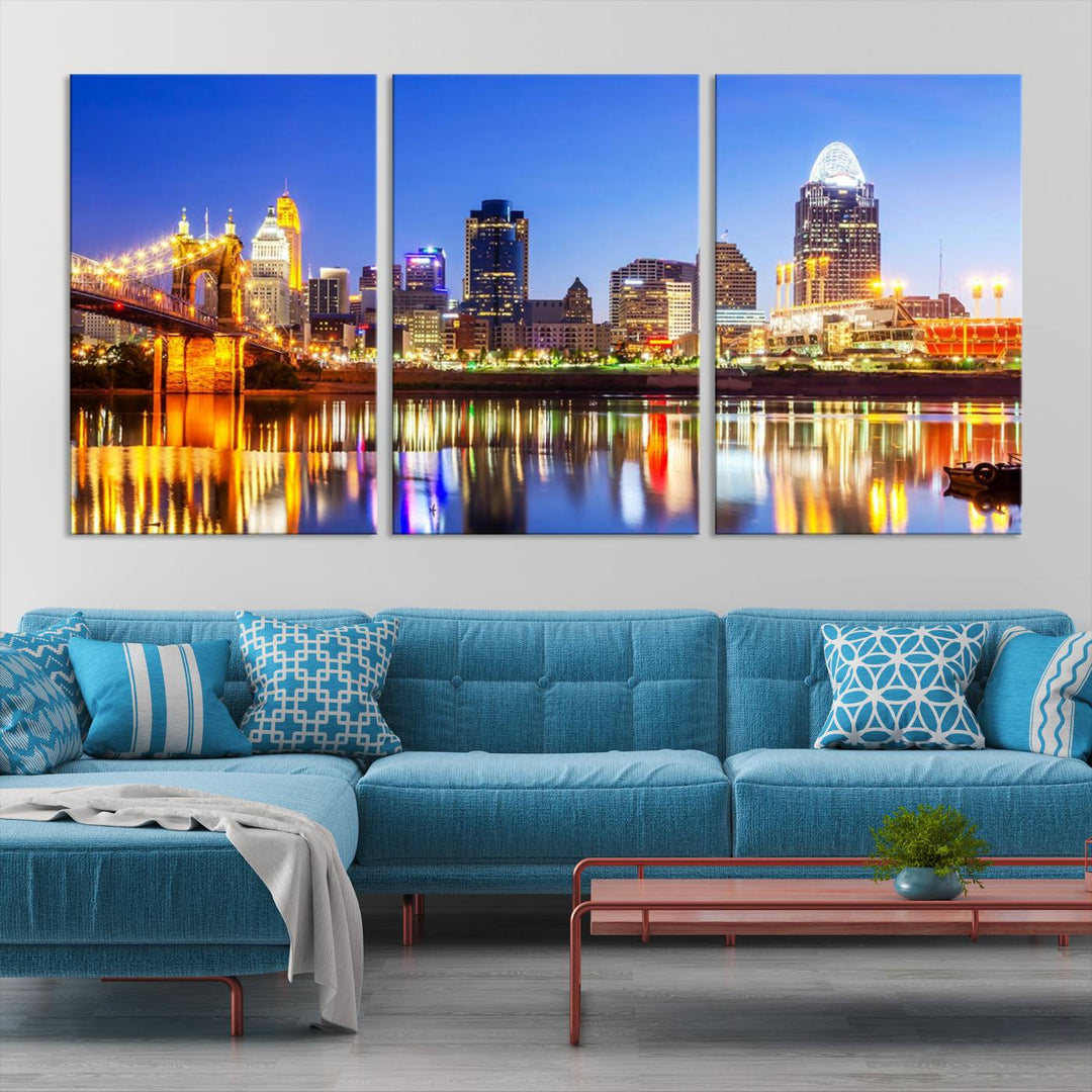 The "Cincinnati City Lights Night Skyline Cityscape View Wall Art Canvas Print" is a gallery-wrapped, museum-quality canvas illustrating a lit-up bridge and skyline at night. Enhanced with a UV-protective coating, this piece ensures lasting vibrancy.