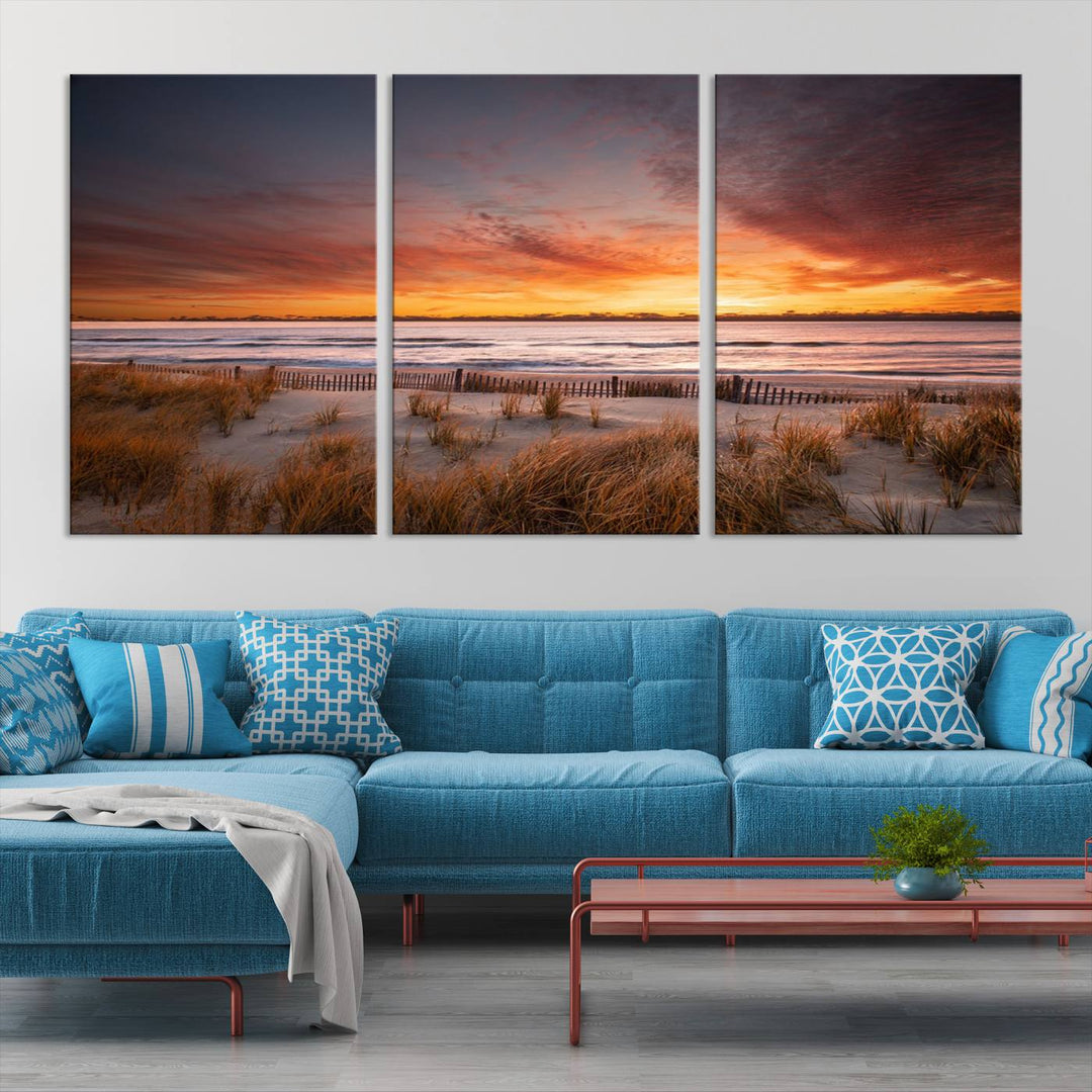 Sunset on The Beach Wall Art Canvas Print features a triptych of a beach at sunset with vivid orange skies, presented on museum-quality canvas. Each section is gallery wrapped, offering lasting beauty with its UV-protective coating.