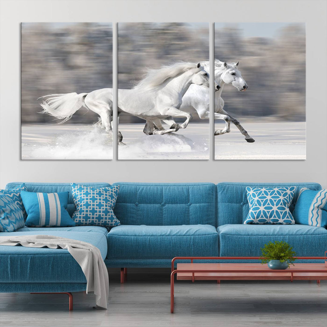 The "All The White Horses Wall Art Canvas Print" depicts a triptych of galloping white horses across a snowy landscape. These museum-quality canvases come with a UV-protective coating to maintain their stunning appearance over time.