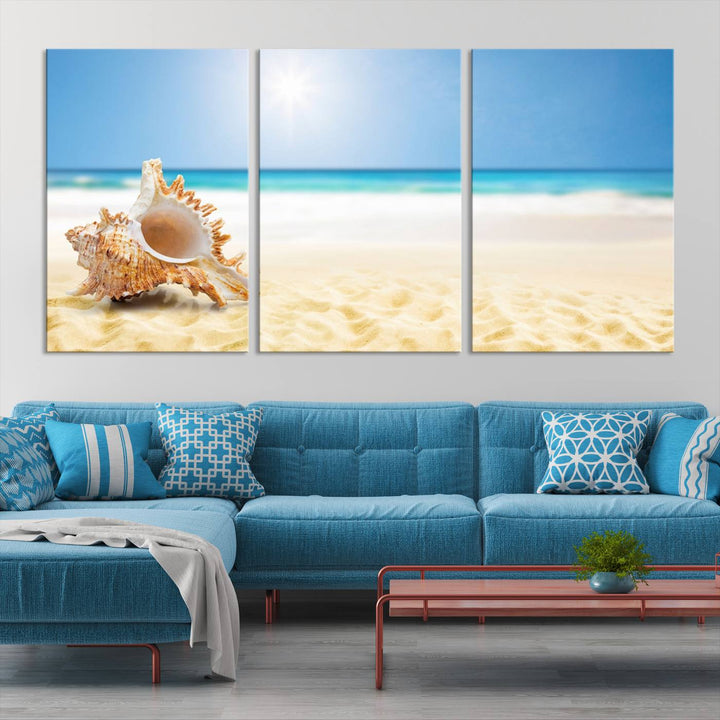 The Sea Shell on The Beach Sun Sand Wall Art Canvas Print is a triptych that beautifully captures a beach scene with a large seashell on the sand.