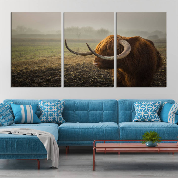 The "Big Cow Horn Wall Art Canvas Print" is a hand-assembled framed canvas depicting a Highland cow in a misty field. It is crafted with a UV-protective coating to ensure lasting vibrancy.