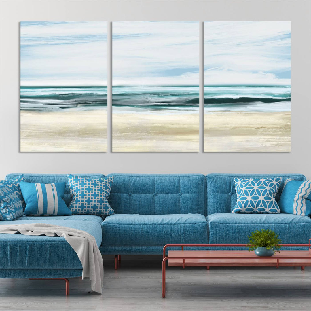 The room features the Ocean Abstract Wall Art Canvas Print, a triptych beach painting on museum-quality canvas with a gallery-wrapped finish and UV-protective coating.