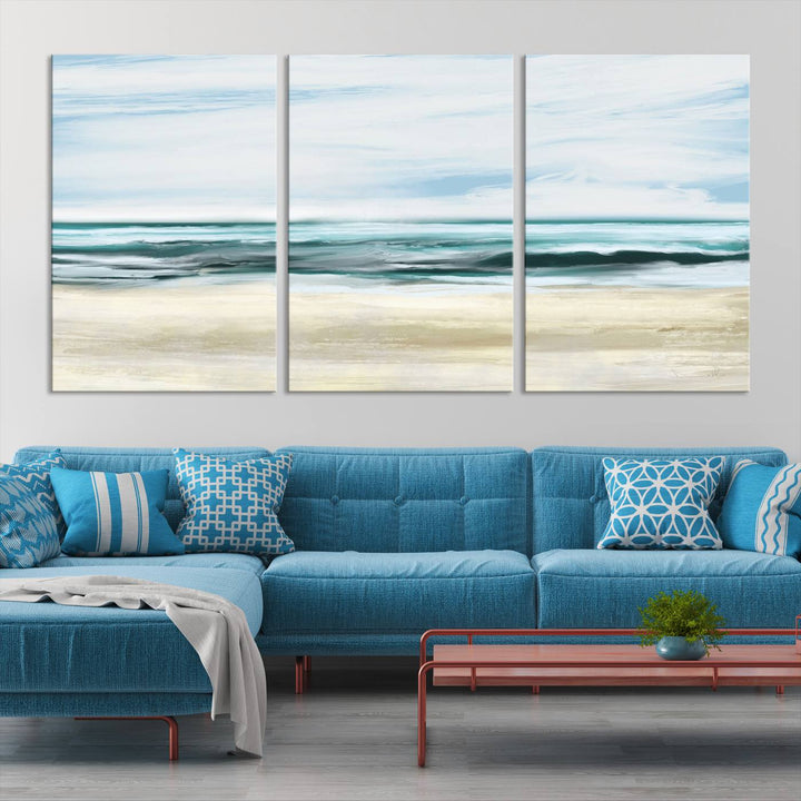 The room features the Ocean Abstract Wall Art Canvas Print, a triptych beach painting on museum-quality canvas with a gallery-wrapped finish and UV-protective coating.