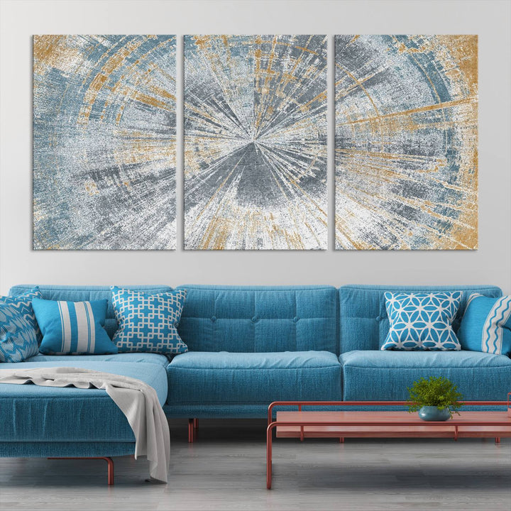 The Radiant Abstract Wood Rings Canvas Art, a modern triptych wall decor, enhances the contemporary style of the living room with its blue, white, and gold hues.