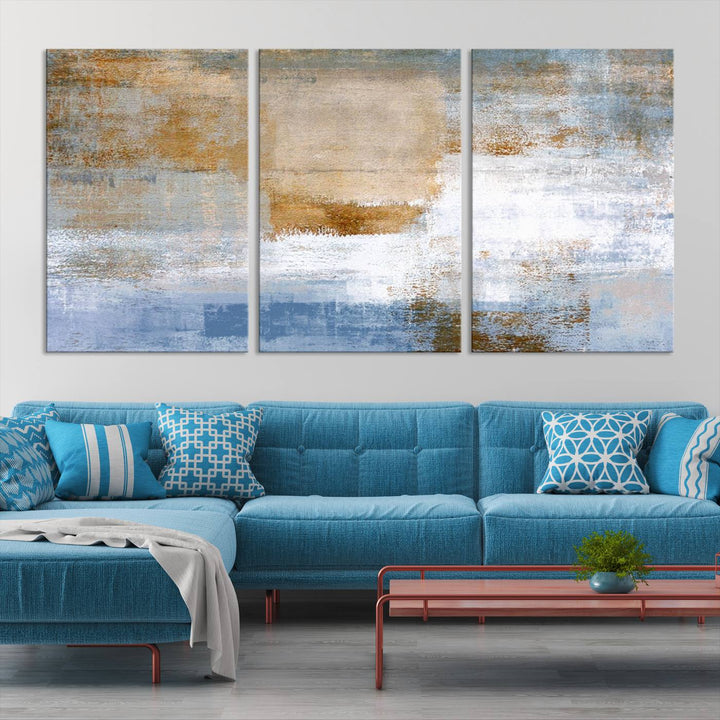 The Blue Multi Panel Abstract Wall Art Canvas Print, featuring an elegant blend of blue, beige, and brown tones, hangs gracefully on the wall, adding a contemporary touch to the space.