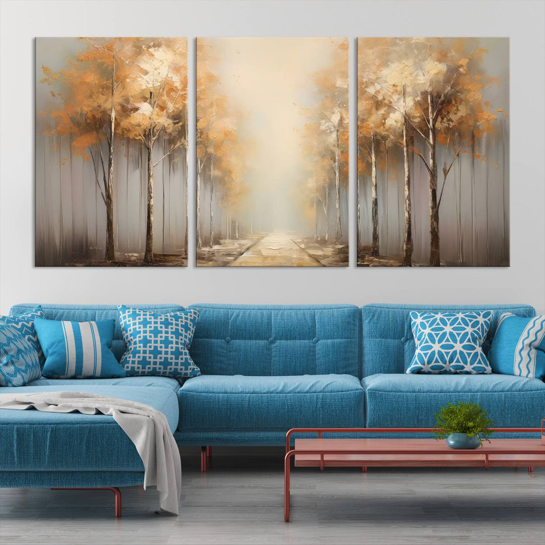 A breathtaking Autumn Forest Path Wall Art, a large canvas print perfect for the living room, bedroom, or office decor, elegantly enhances the area above a white sofa.