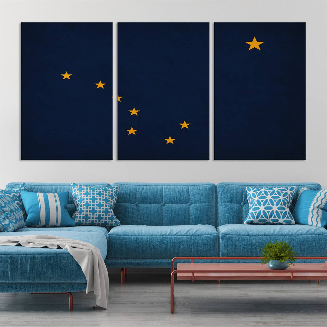 A contemporary living room featuring a triptych artwork of stars on a navy background, accentuated by the striking Alaska States Flag Wall Art Canvas Print.