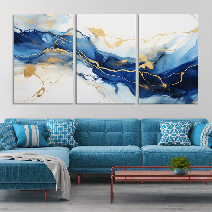 The Blue Abstract Wall Art is displayed as a triptych on museum-quality canvas, showcasing a blue and gold abstract design. The artwork includes a UV-protective coating to maintain its vibrancy and comes with the benefit of free shipping.