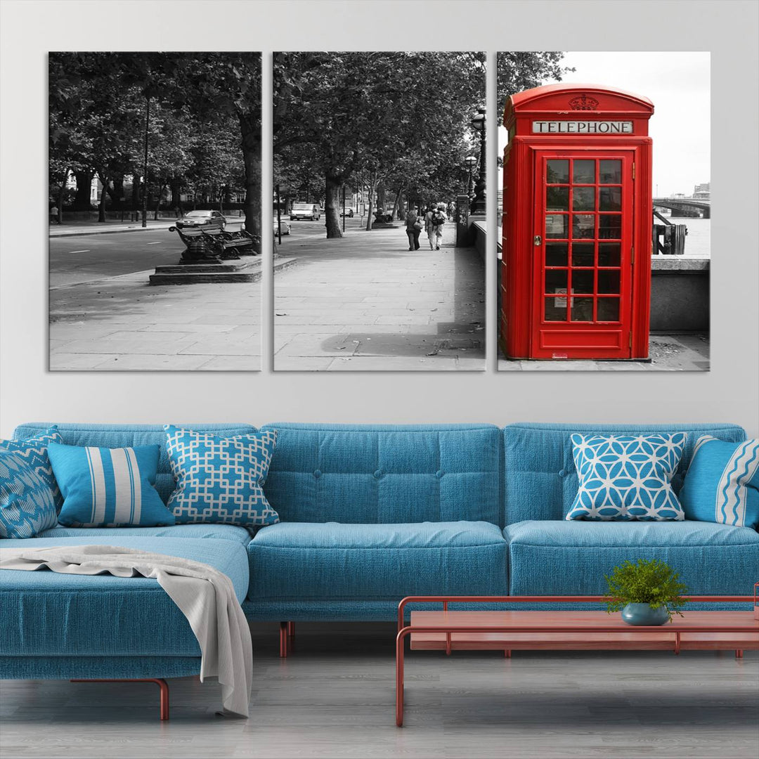 The London Phone Club Wall Art is a stunning piece that showcases a red telephone box set in a black and white street scene on museum-quality canvas. It is gallery wrapped with a UV-protective coating to preserve its vibrant charm.