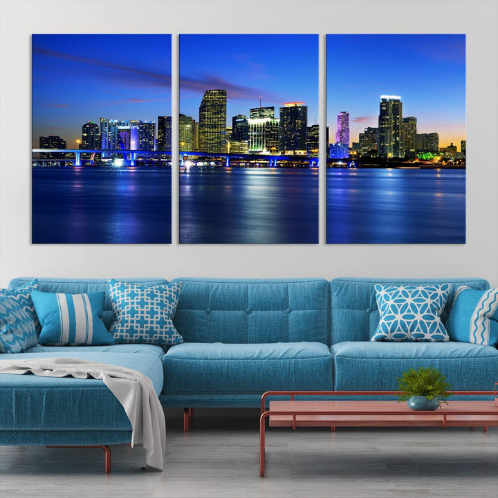 The modern living room showcases a striking Miami Blue Night Wall Art canvas print on the wall. The artwork is gallery wrapped on museum-quality canvas, ensuring durability and elegance.