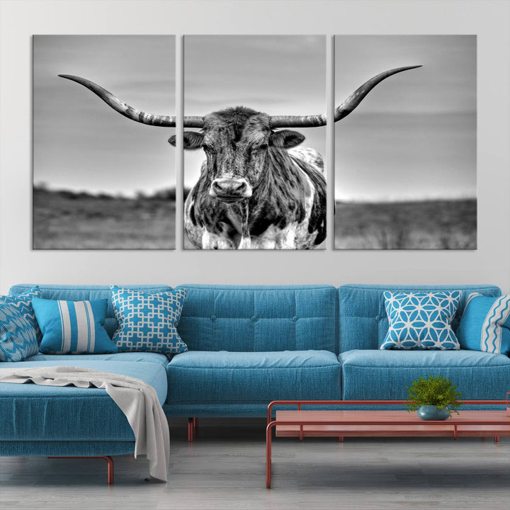 The Texas Longhorn Cow Wall Art, featuring a black and white image of a longhorn bull on canvas, brings charm to the room with its sophisticated appeal.