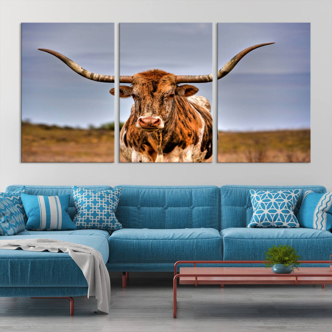 The Texas Longhorn Wall Art Print, a triptych canvas artwork depicting a longhorn bull in a field, features a gallery-quality finish.