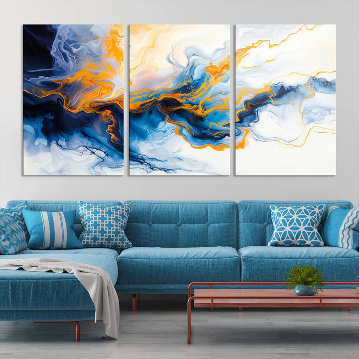 A stunning Fluid Alcohol Ink Wall Art with Gold Wall Art Canvas Print, featuring vibrant blue, orange, and white swirls, adorns the wall. This gallery-quality finish adds an exquisite touch to any living space.