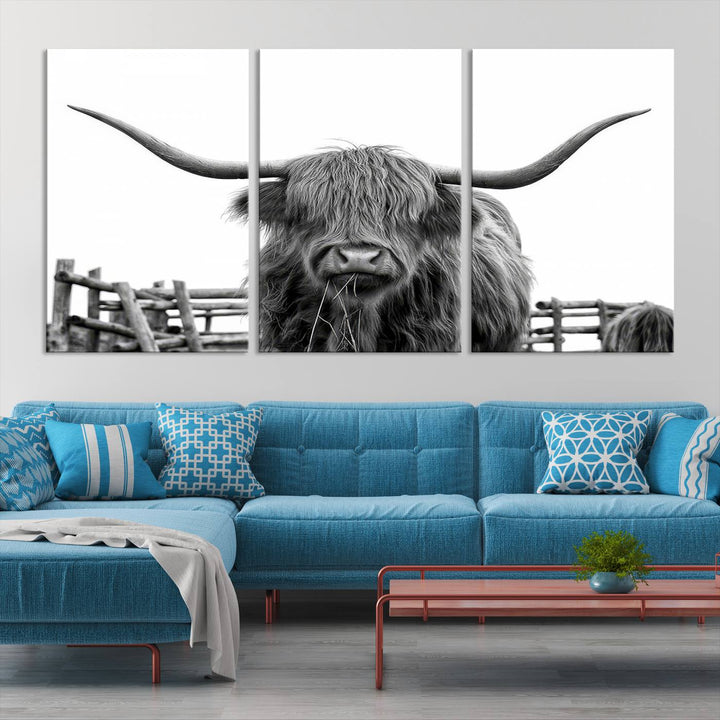 The Longhorn Canvas Print, featuring a black-and-white triptych of a Bighorn cow with shaggy fur and impressive long horns, is elegantly showcased. This wall art piece boasts a gallery-quality finish on premium canvas, bringing sophistication to any room.