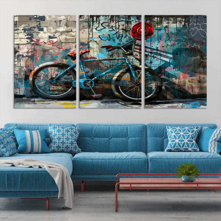 A modern living room features a triptych wall art of an abstract bicycle, designed in a graffiti style on a brick wall. This piece is expertly crafted on the Abstract Bicycle Wall Art Canvas Print, offering a premium canvas that ensures a gallery-quality finish.