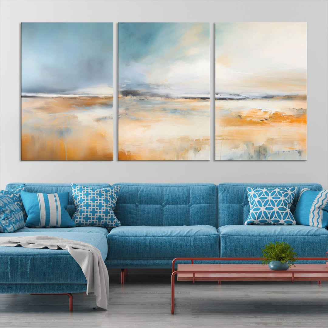 The Abstract Landscape Wall Art Canvas Print, featuring warm tones of orange and blue, is displayed on a dark wall.