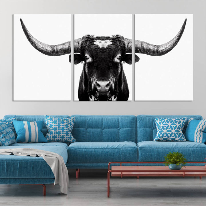 The living room is adorned with the Texas Cow Longhorn Wall Art Canvas Print in Black and White—framed and ready to hang.